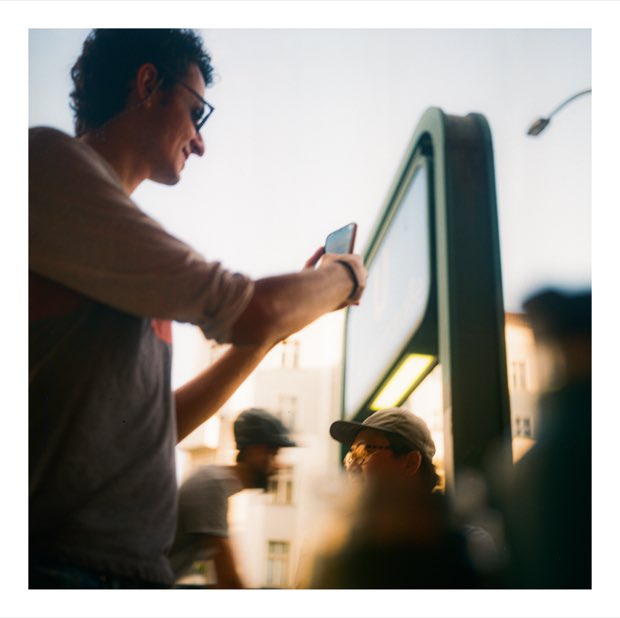 Karam filming on his phone at sunset