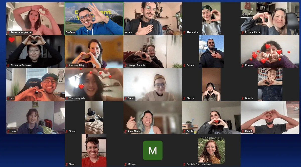 Participants making heart gestures together on a Slow Creator Zoom call